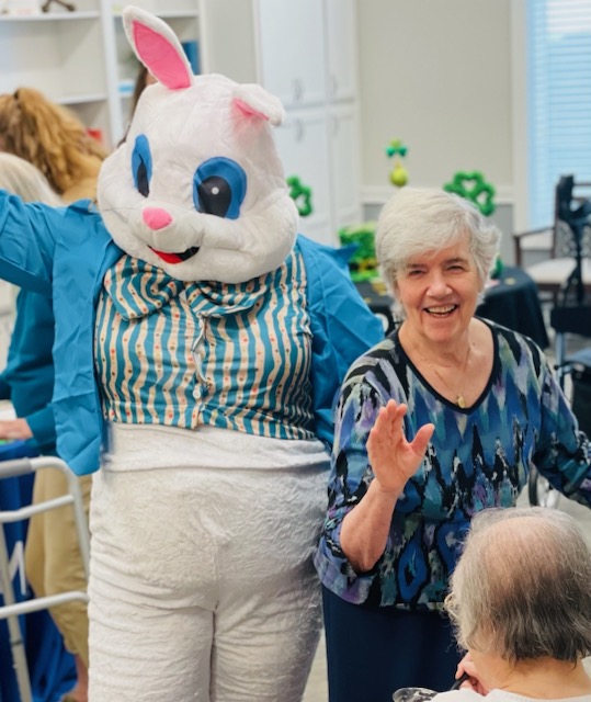 The Easter Bunny brings joy to seniors at the living community, spreading smiles and laughter during the Easter event.