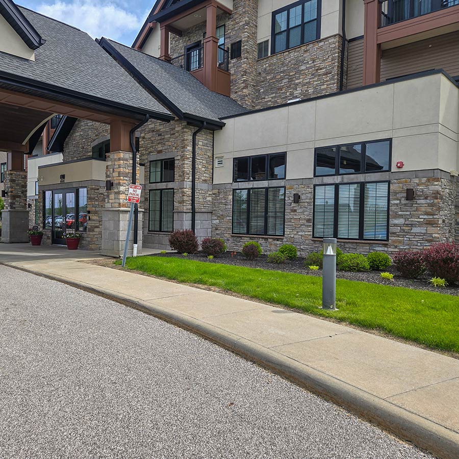The exterior of Vitalia Montrose, lined with landscaped flower beds.
